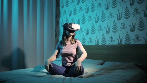 Woman Is Sitting in Bed in Virtual Reality 3d Glasses and Waving Hands in Air