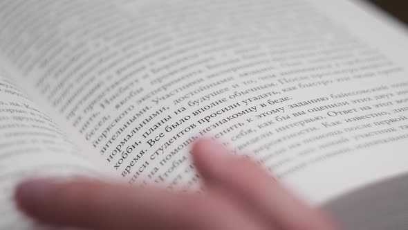 Turning Pages of a Book CloseUp Slow Motion alt