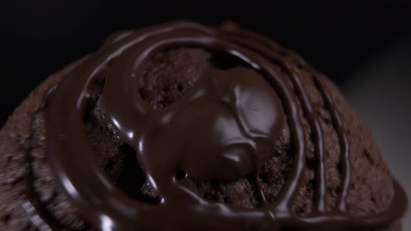 Chocolate cake brownie rotating in front of camera on black background alt