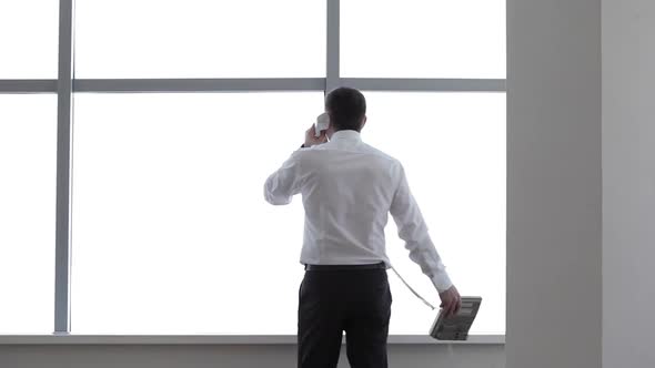 Businessman Talking on the Phone in his Office