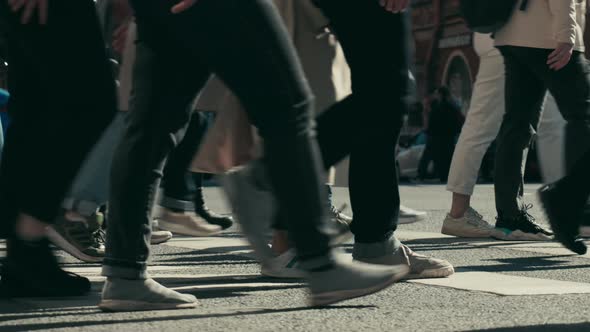crowd of people walks down the street of the city alt