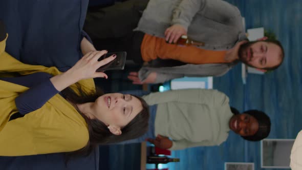 Vertical Video Multiracial Friends Hanging Out Together Socializing While Looking at Funny Video alt