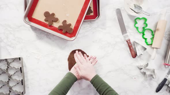 Flat lay. Step by step. Rolling out gingerbread cookie dough to bake Christmas cookies. alt