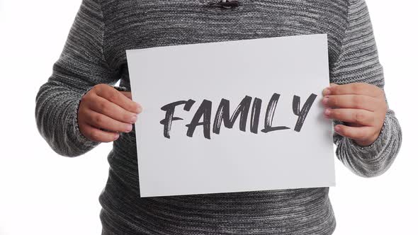 A person holding a sign with the message and the word "family" alt