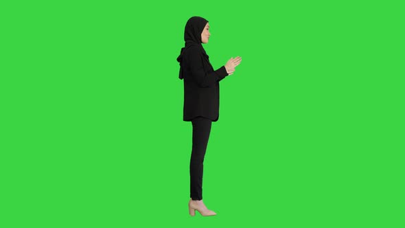 Confident Young Muslim Business Woman Wear Hijab Speaking To Camera on a Green Screen, Chroma Key. alt
