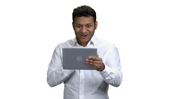 Shocked Man Looking at Digital Tablet alt