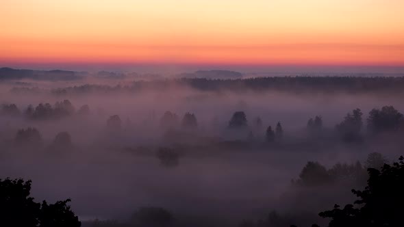 Amazing scenic early morning misty landscape just at sunrise