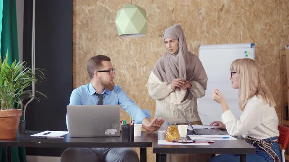 Muslim Woman Is Helping To Her Male and Female Colleagues in Office alt