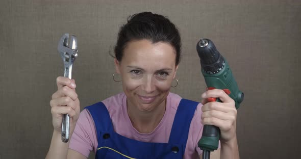 Drill and Tool in Woman Hand alt