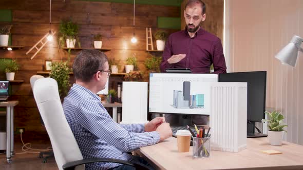 Team of Architects in the Office Talking About Design for the New City Skyscrapers alt