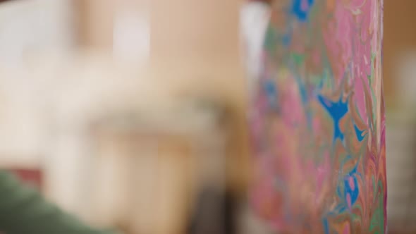 Girl Looks at Picture with Ebru Patterns Held By Woman alt