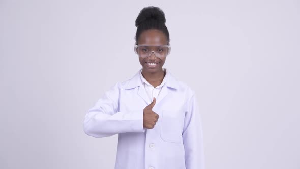 Young Happy African Woman Doctor with Protective Glasses Giving Thumbs Up alt