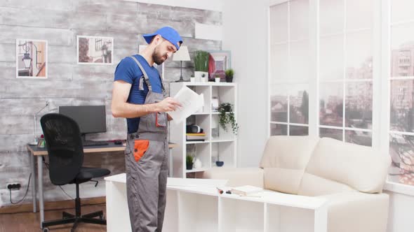 Male Worker Can't Figure Out the Instruction for Furniture Assembly alt