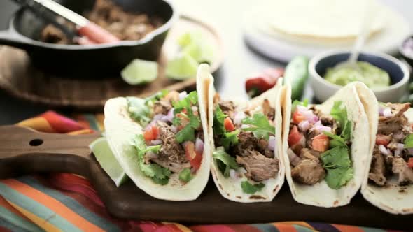 Pulled pork carnitas with pico de gallo on a flour tortilla. alt