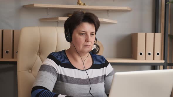 Old Woman Wearing Headset, Holding Video Call Support Services with Customer. alt