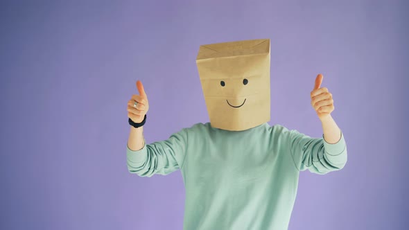 Person with Paper Bag on Head Showing Thumbs-up Gesture and Moving Body Dancing alt