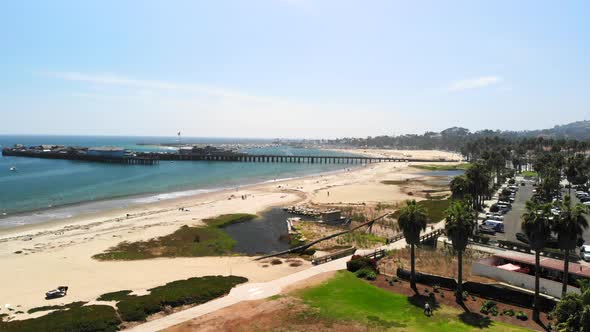 Aerial shot above Chase Palm Park looking out at the harbor in the dark blue Pacific Ocean next to S alt