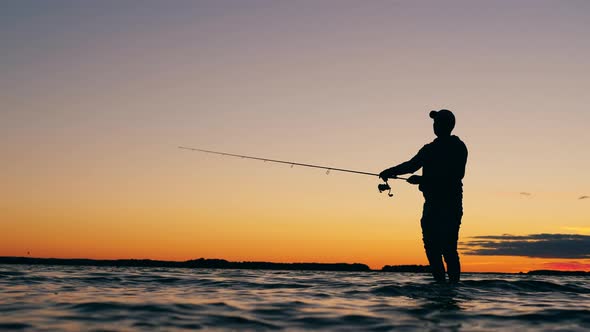 Sunset Lake with a Man Casting a Fishing Rod, Stock Footage | VideoHive