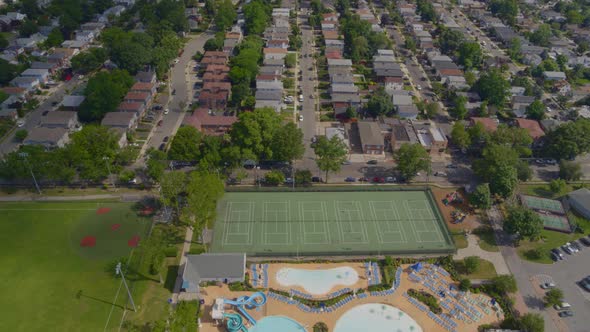 Flying Over a Pool Complex and Towards a Suburban Neighborhood in Long Island alt