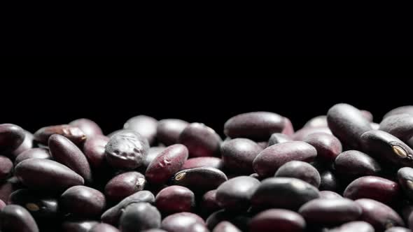 Close up of a bunch of red beans on a black background, dry red beans abstract background