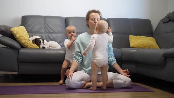 A Mother Trying to Focus and Practice Yoga While Her Twin Babies Keep Bothering Her alt
