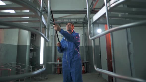 Paint shop foreman prepares items for painting in the paint shop