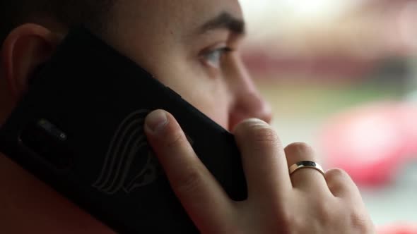 a man is driving and talking on the phone. Dangerous driving.