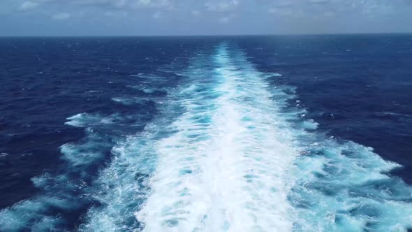 Footage from the back of a large boat traveling through the Atlantic sea