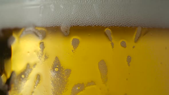 Glass of beer close-up with froth