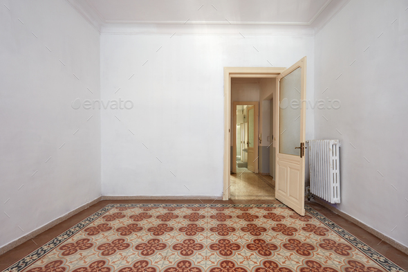Empty room interior with ancient tiled floor and wooden door Stock Photo by andreahast