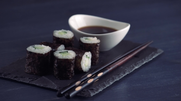 Sushi Roll on Black Slate Plate in Japanese Restaurant