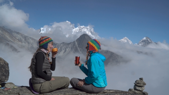 Two Girls Are Drinking Tea in the Mountains alt