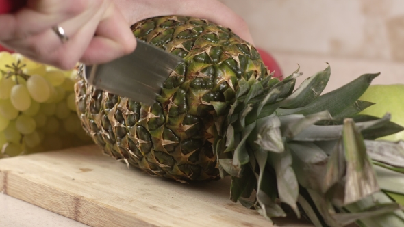 The Cook Cuts a Big Pineapple