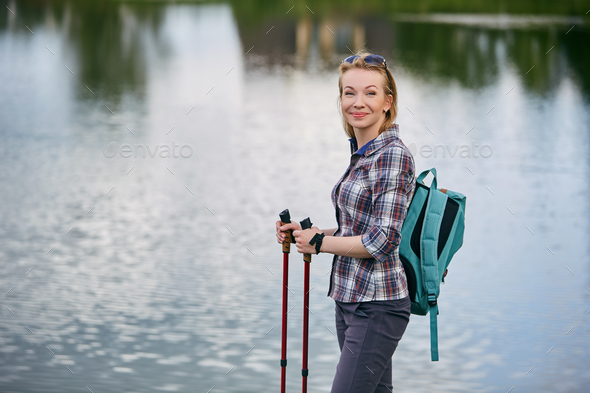 young woman with nordic walk pols