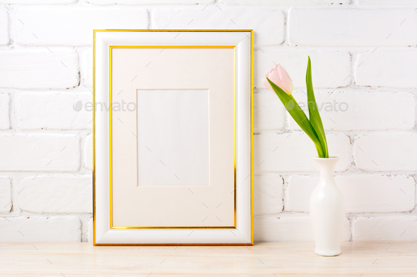 Gold decorated frame mockup with pale pink tulip in vase