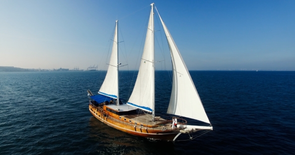 The Boat Captain Is Hugging the Happy Woman in the Long White Dress on the Boat