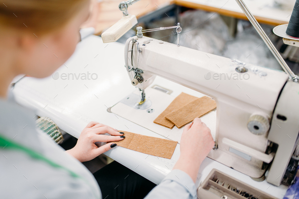 Seamstress with measuring tape, textile workshop Stock Photo by NomadSoul1