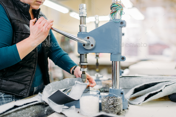 Female tailor works on riverting machine - Stock Photo - Images