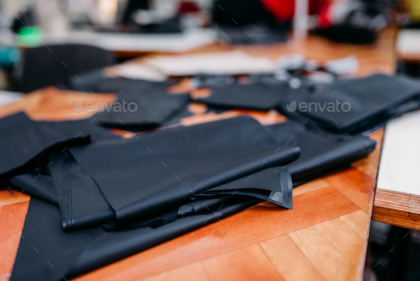 Seamstress with measuring tape, textile workshop Stock Photo by NomadSoul1