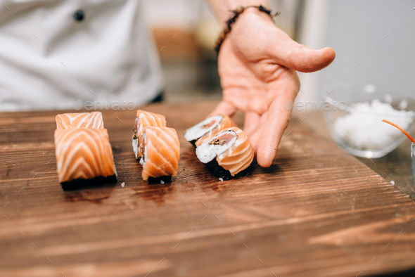 Male person cooking sushi, japanese kitchen - Stock Photo - Images