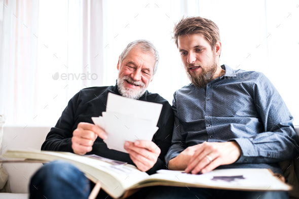 Hipster son and his senior father at home. Stock Photo by halfpoint