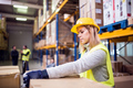 Female warehouse worker loading boxes. - PhotoDune Item for Sale