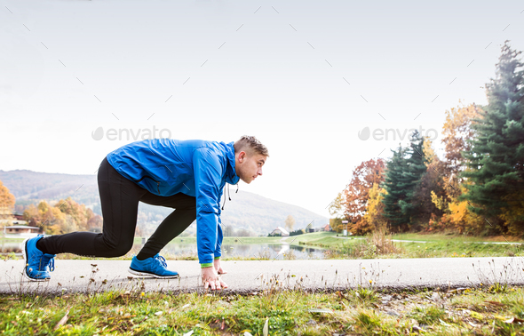 Runner at the lake on asphalt path in steady position. - Stock Photo - Images