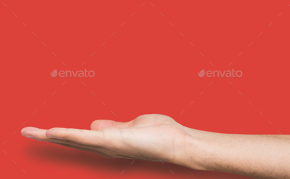Outstretched male hand over pink background - Stock Photo - Images