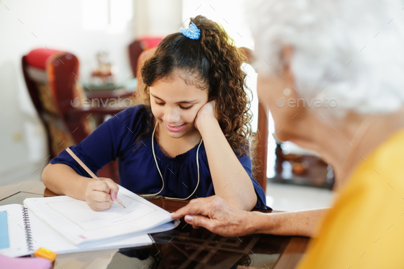 Elderly Woman Helping Little Girl Doing School Homework - Stock Photo - Images