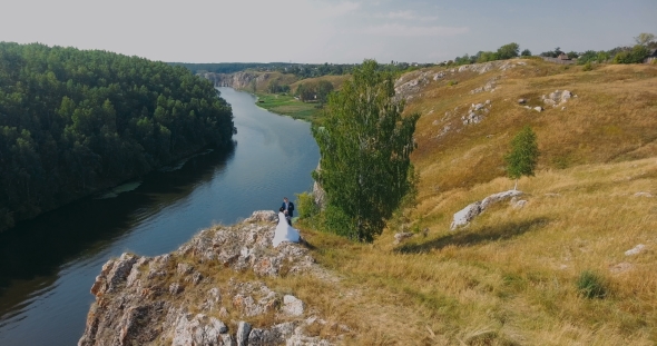 Beautiful Bride and Groom Wedding Couple on a Rock alt