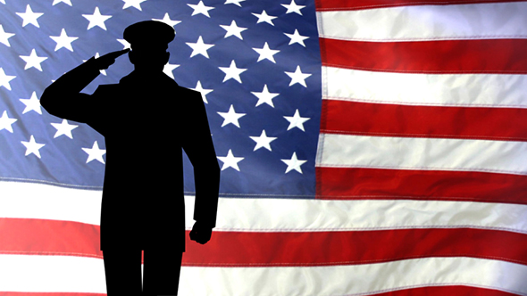 Silhouette Of A US Army Officer Saluting Against The American Flag