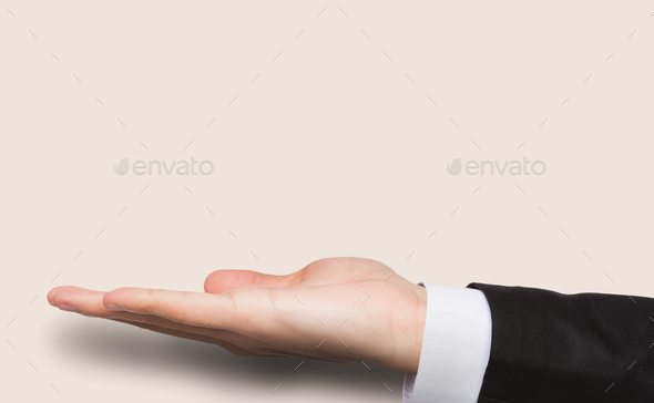 Outstretched male hand over pink background - Stock Photo - Images