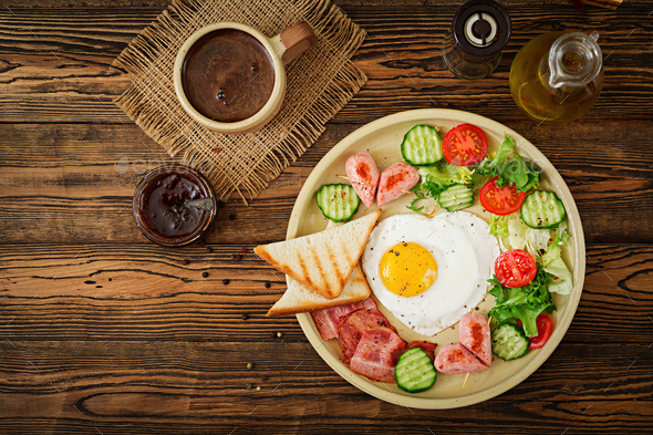 Breakfast on Valentine's Day - fried egg in the shape of a heart - Stock Photo - Images
