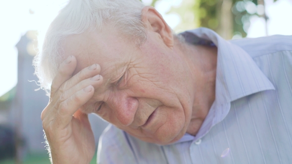 Portrait of Tired, Sad Senior Thinks with Worrying at Camera alt